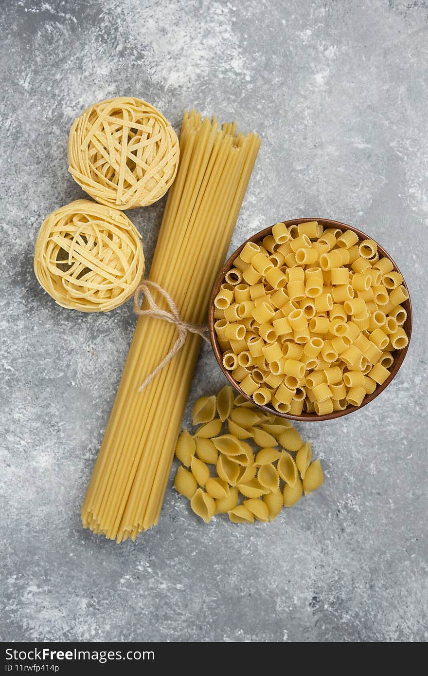 Raw pasta and spaghetti varieties on marble background. High quality photo