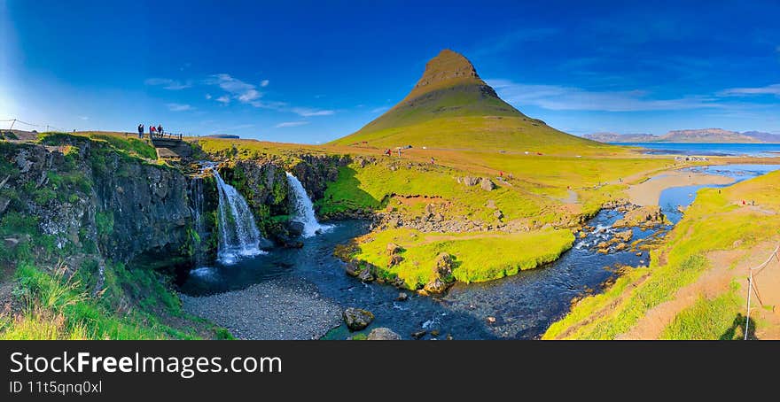 Kirkjufellfoss scenic spot with iconic waterfall and peak in Iceland, panoramic view