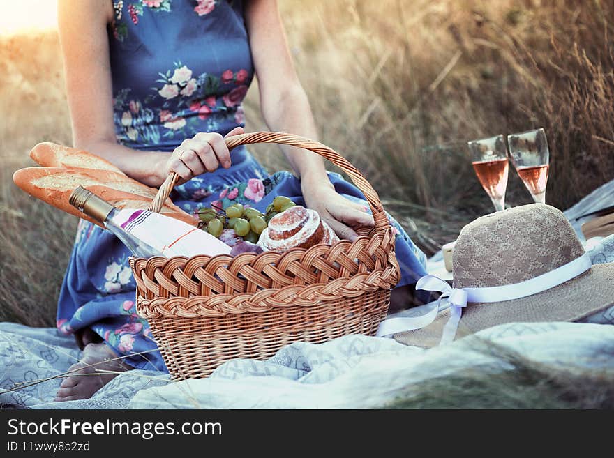 Summer - Provencal picnic in the meadow.  girl smiling girl with a basket on a picnic