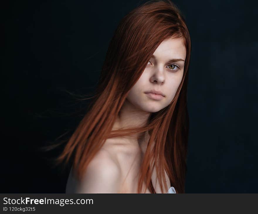 woman with bare shoulders on a dark background clean skin cosmetology model. High quality photo