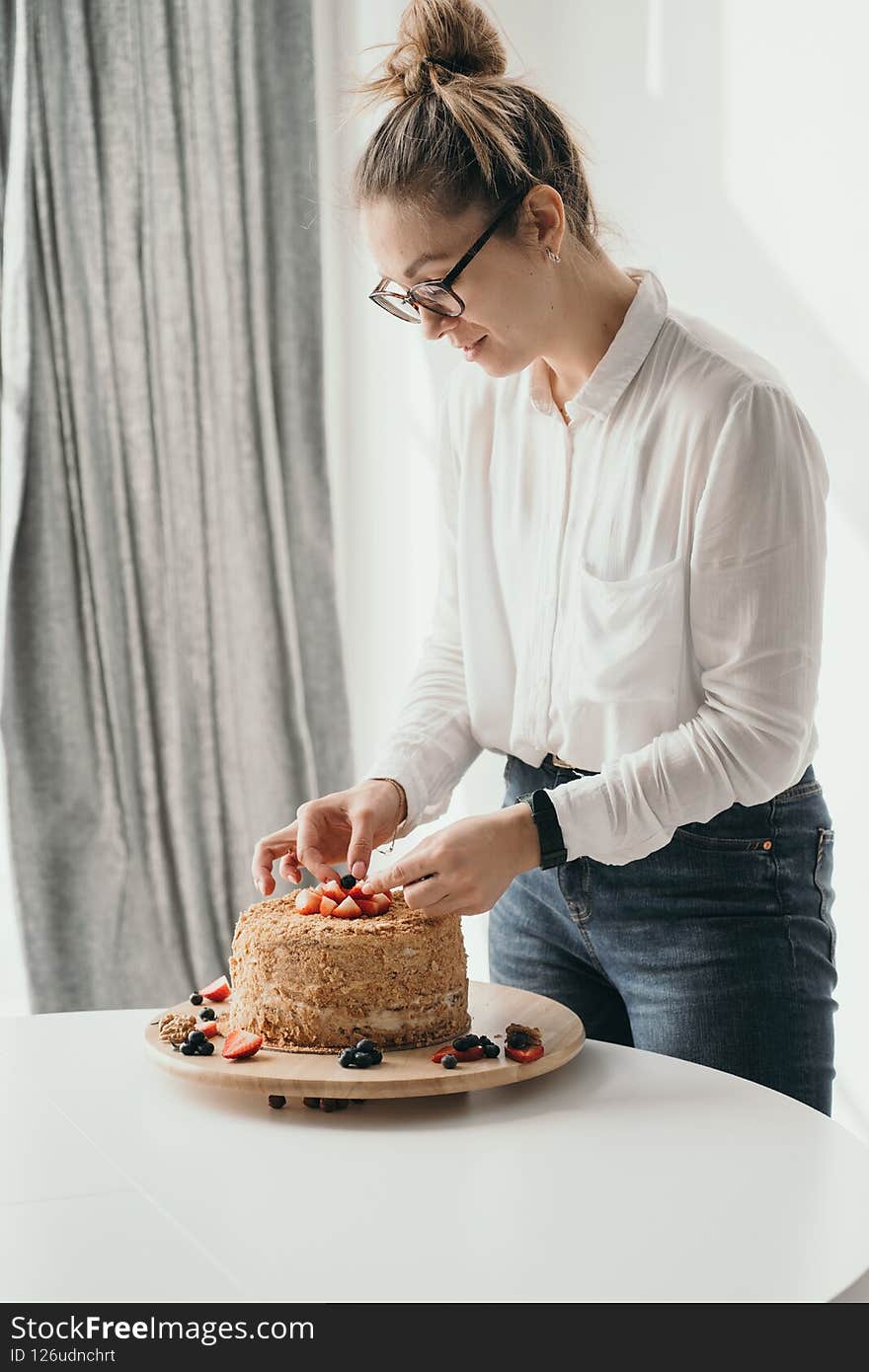 The pastry chef holds a mixer in his hands. A housewife prepares a cake. Portrait of a pastry chef at work.
