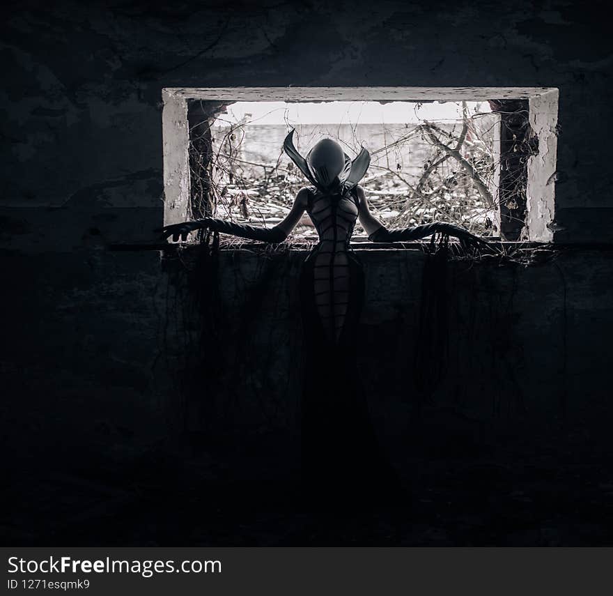 Woman portrays alien creature inside abandoned house