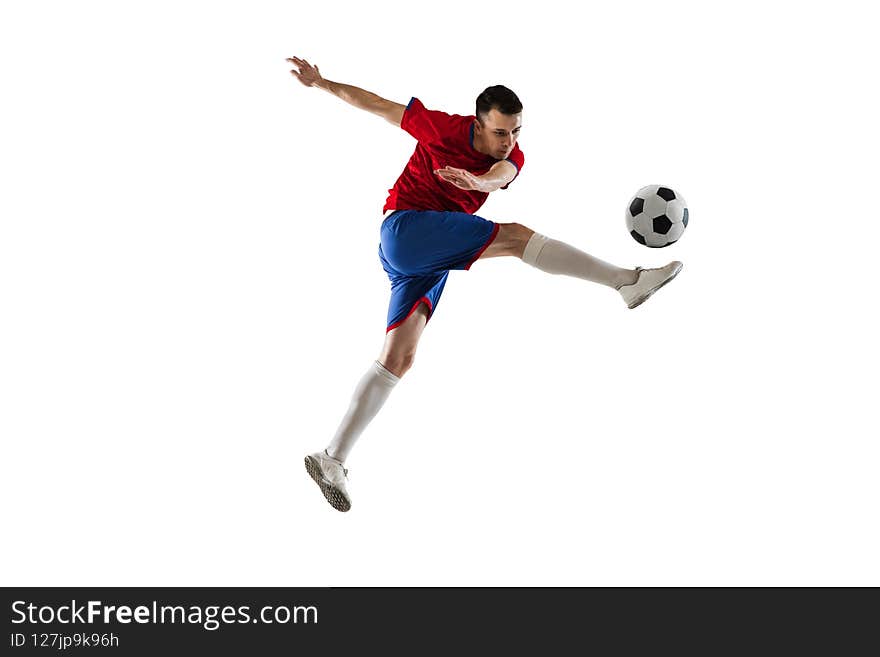 Kick the ball. Young Caucasian man, male soccer football player in red blue uniform isolated on white background. Action, dynamic. Concept of active life, team game, energy, sport. Copy space for ad. Kick the ball. Young Caucasian man, male soccer football player in red blue uniform isolated on white background. Action, dynamic. Concept of active life, team game, energy, sport. Copy space for ad.
