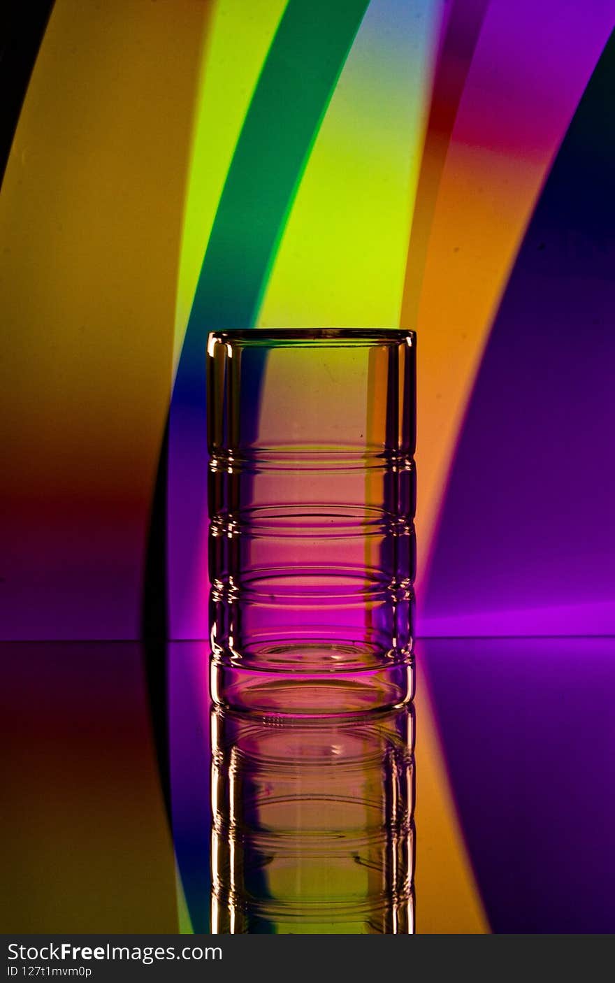 Glass on the background of colored lines. Glass on the background of colored lines