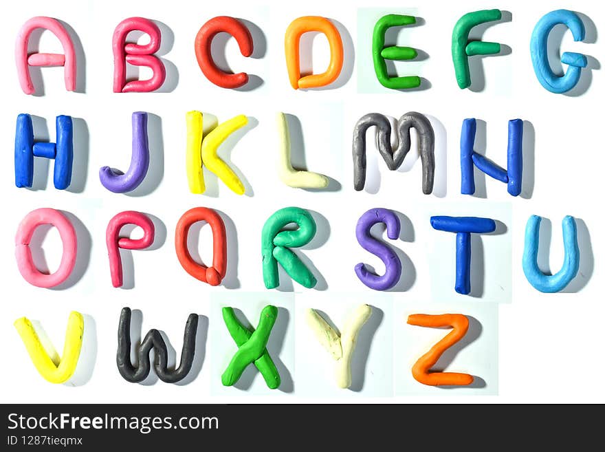 Colored English letters made of plasticine. Alphabet isolated on white background. Flat lay. copy the space