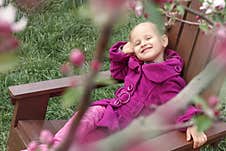 Spring Garden Baby. Little Girl In Spring Garden Near Flowers. Royalty Free Stock Images