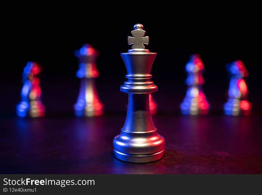 Golden King chess standing in front of other chess, Concept of a leader must have courage and challenge in the competition