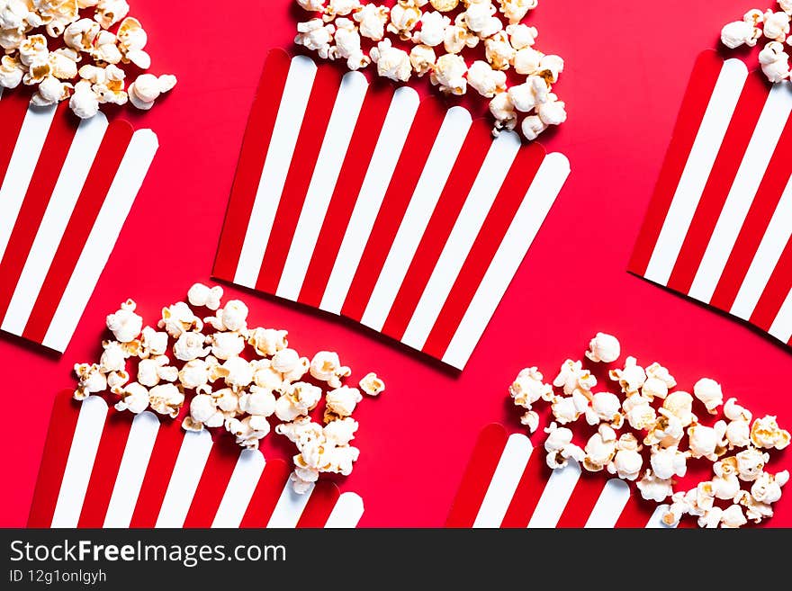 Striped Popcorn Bukcets on Red Background. Cinema and Movies Conccept. Flat Lay Box Officce Background