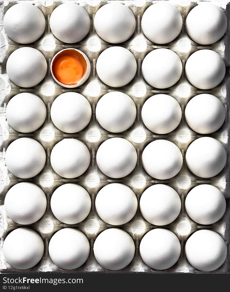 Open Egg with Yolk Stand Out from White Eggs Crowd. Flat Lay Top Down Abstract Patter food Image
