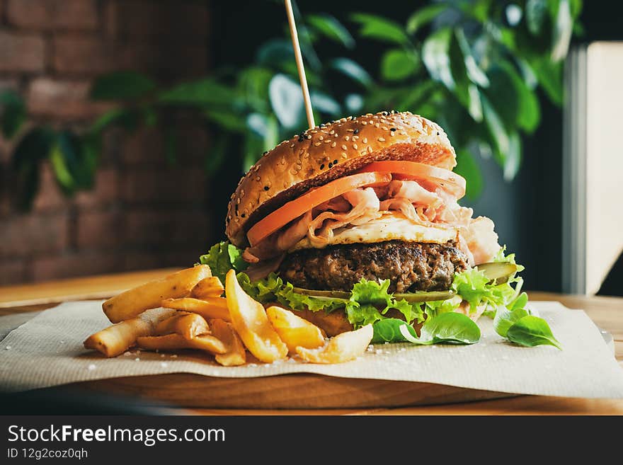 Beef Egg and Bacon Burger Served in Restaurant. American Food. Tasty Gourmet on Wooden Table