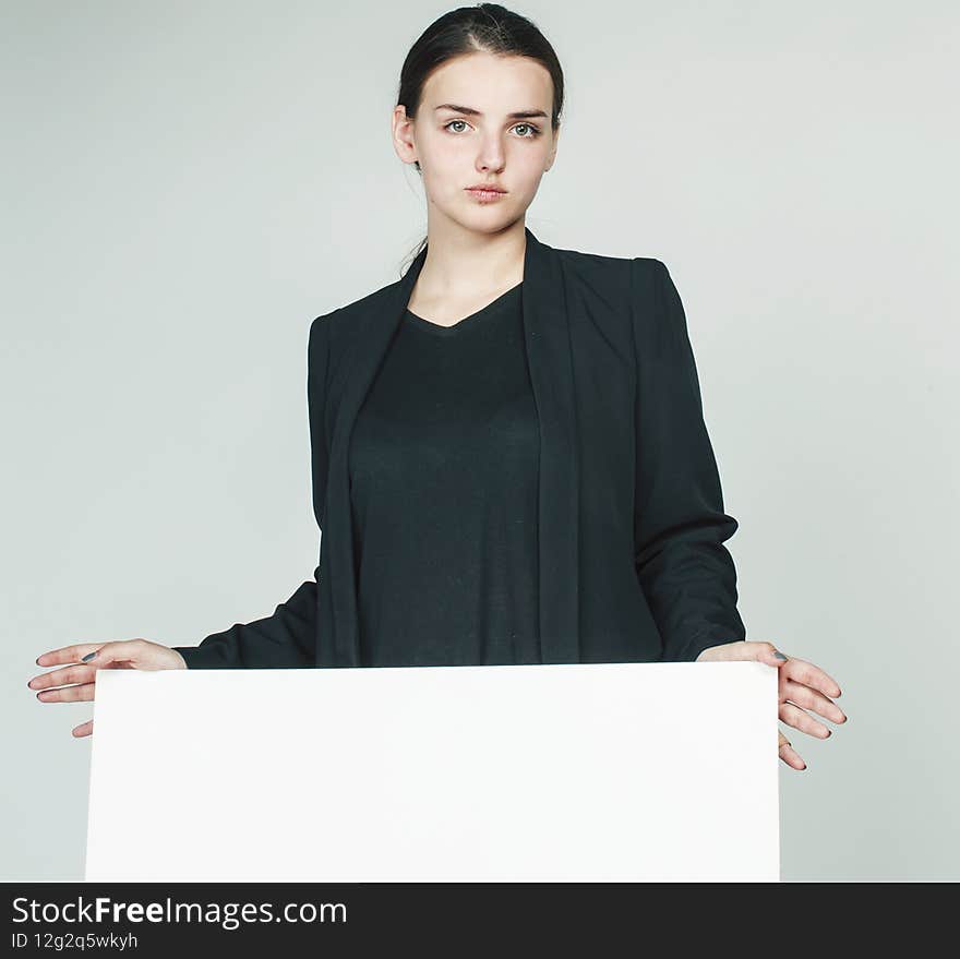 young pretty brunette girl with placard shit copyspace on white background wearing business costume student