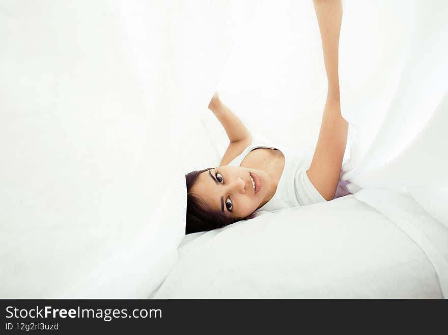 Young Pretty Tann Woman In Bed Among White Sheets Having Fun, Trying To Sleep, Fooling Around
