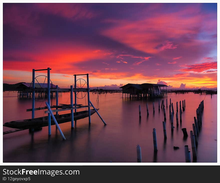 Beautiful scenery after the sunset of a fishing village on the lake