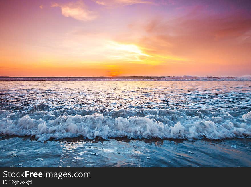 Radiant sunset from Bali Double Six beach surf waves and colorful clouds. Radiant sunset from Bali Double Six beach surf waves and colorful clouds