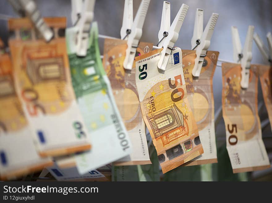 100 and 50 euro banknotes drying. Washed Euro paper bills. Drying euro on a string