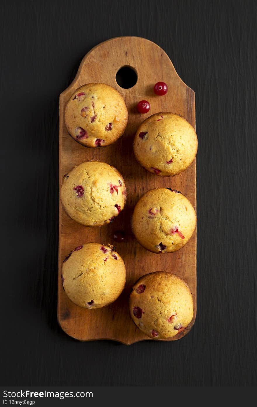 Homemade Cranberry Muffins With Orange Zest On A Rustic Wooden Board On A Black Background, Top View