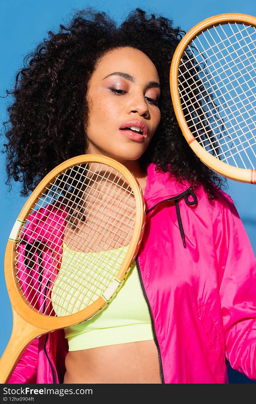 Curly African American Woman Holding Tennis