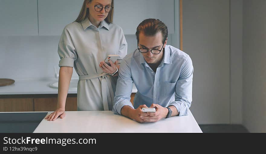 Successful Businessmen Couple Working From Home With Smartphones
