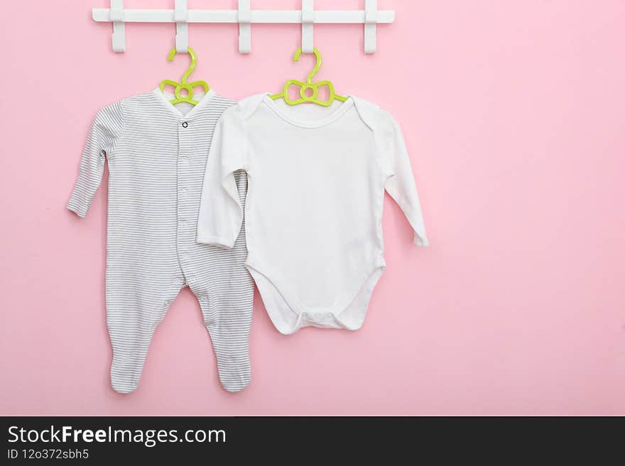 Baby clothes on a hanger. Place for text, minimalism. High quality photo