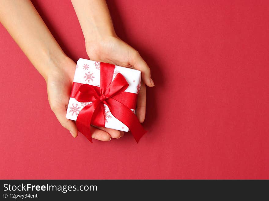 gift in female hands on a colored background top view. High quality photo
