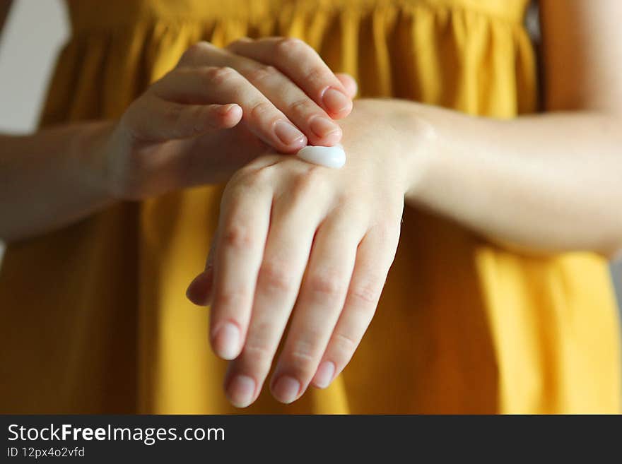 girl smears her hands cosmetic cream. skin care