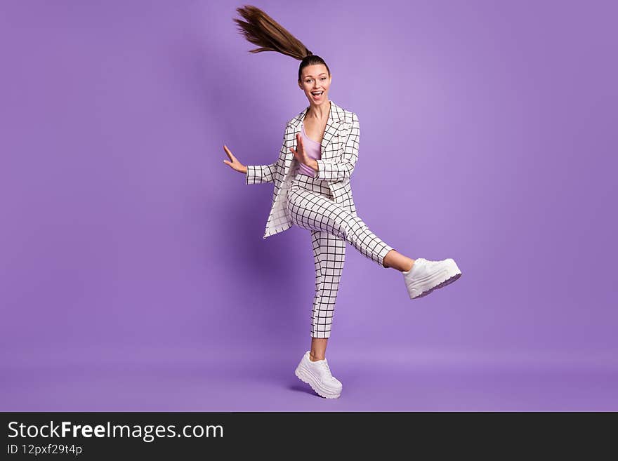 Full size photo of young lovely happy excited crazy positive girl with flying hair dancing isolated on purple color