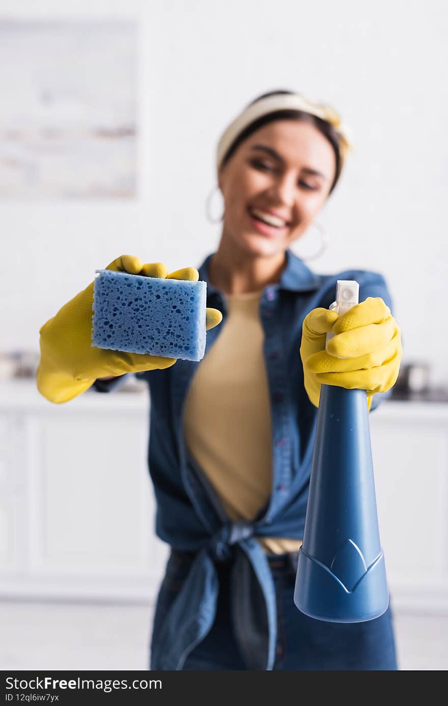 Sponge and detergent in hands of blurred housewife,stock image