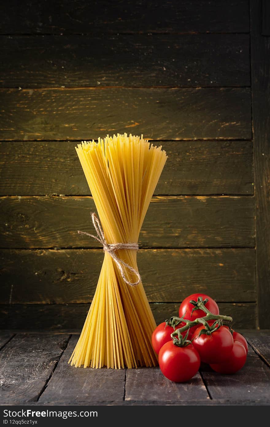 Spaghetti And Cherry Tomatoes. Pasta And Tomatoes On A Black Background