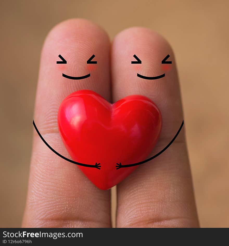 Hearts on finger with blurred wood background, heart background, heart valentines