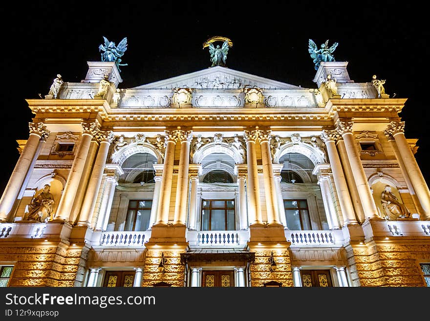 The Opera House glows at night in the city of Lviv.