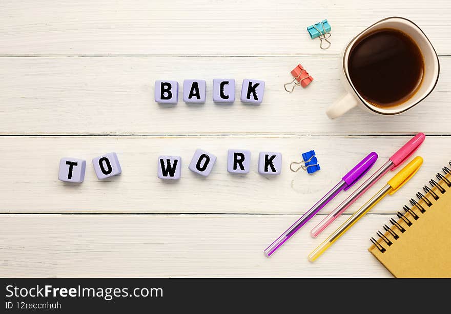 Cubes with the abbreviation BACK TO WORK, coffee and office supplies