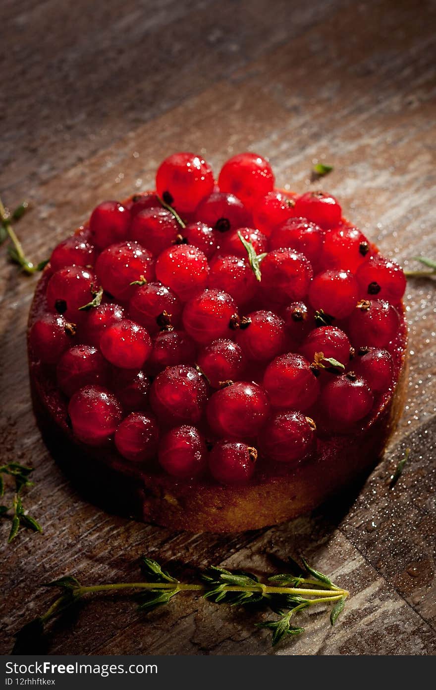 Homemade tarte with redcurrant on a brown table