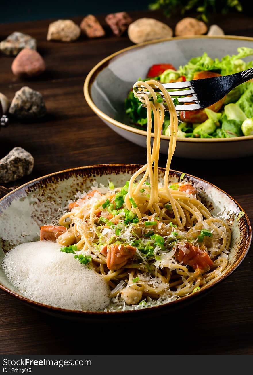 Italian spaghetti on rustic wooden table. Mediterranean cuisine with pasta