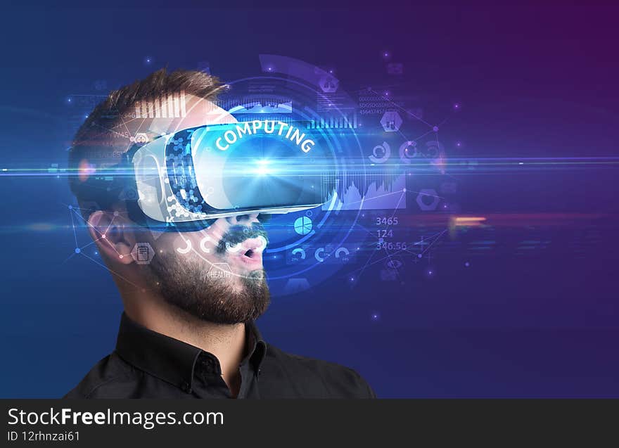 Businessman looking through Virtual Reality glasses with COMPUTING inscription, innovative technology concept. Businessman looking through Virtual Reality glasses with COMPUTING inscription, innovative technology concept