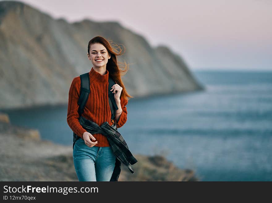 happy woman tourists travel near the sea in the mountains cropped view. High quality photo