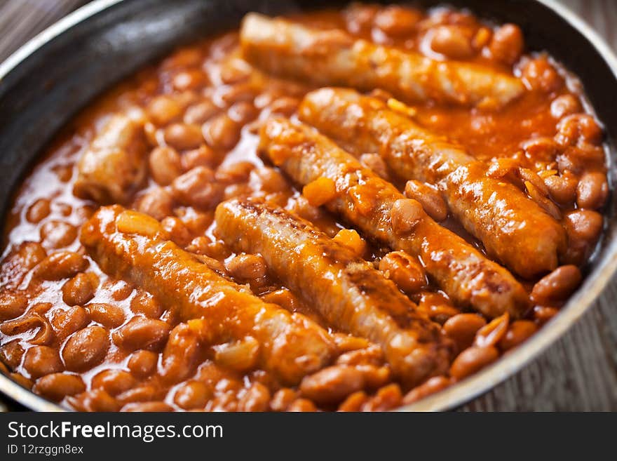 Sausage and Beans with Tomato Sauce on a pan.