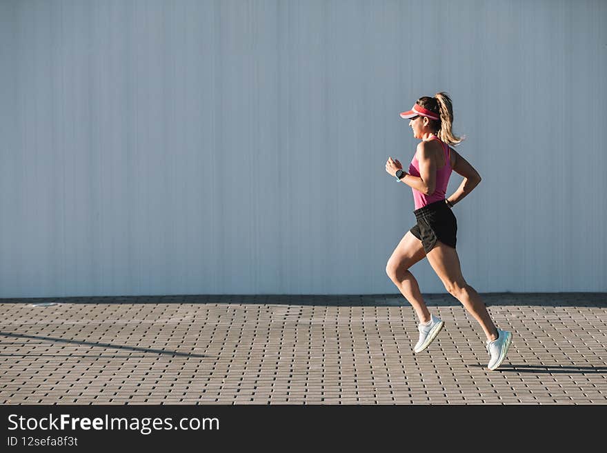 Beautiful young runner running around the city.