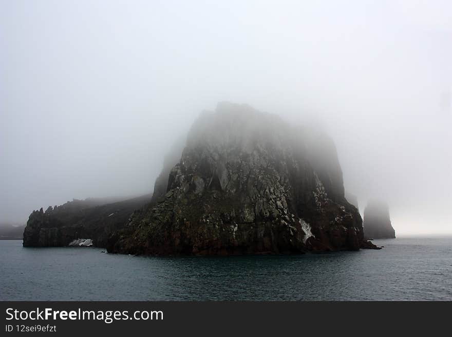 Neptunes Bellows is a strait and the entrance to Deception Island. The island is the summit area of an active volcano. Neptunes Bellows is a strait and the entrance to Deception Island. The island is the summit area of an active volcano.