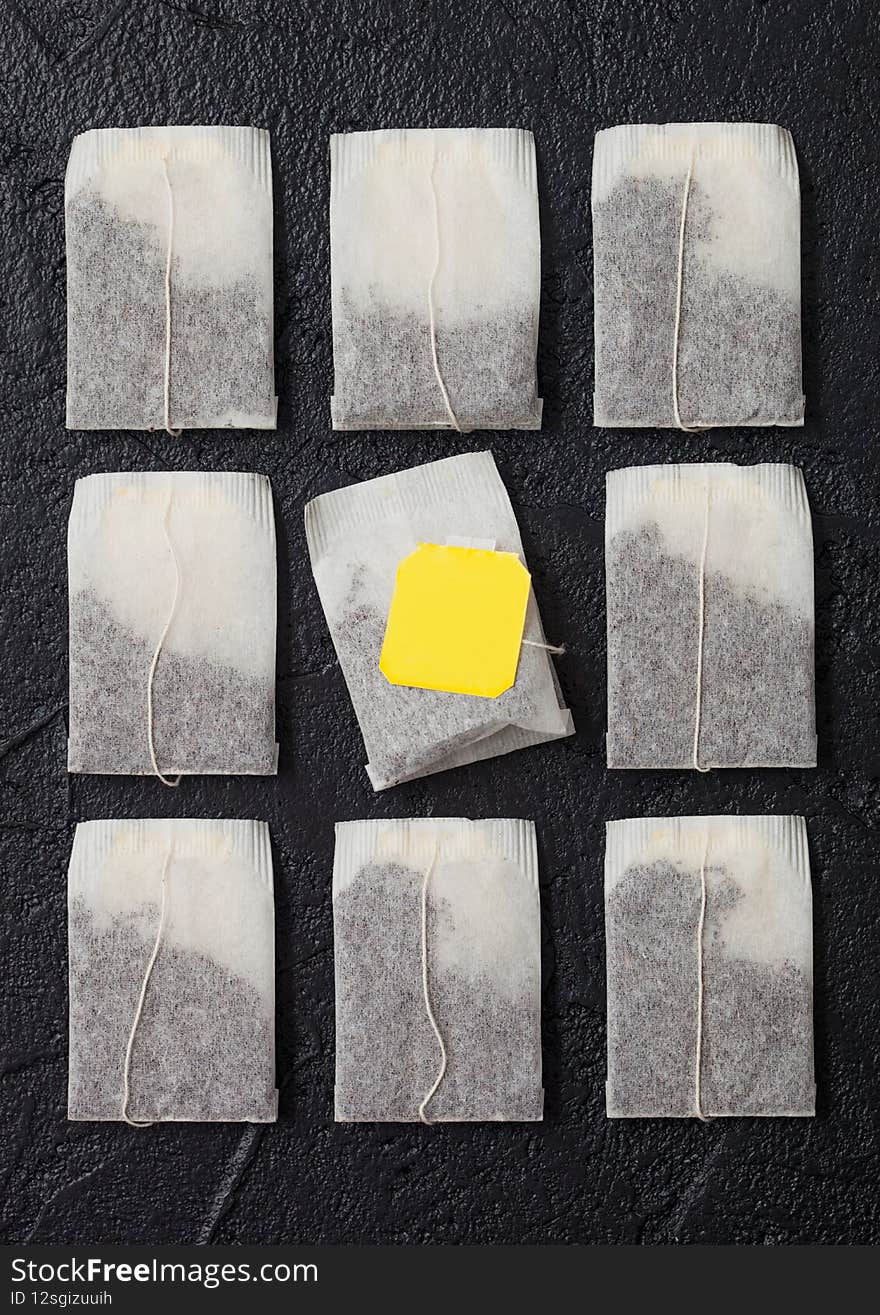 Teabags Of Black Tea With Yellow Tag On Black