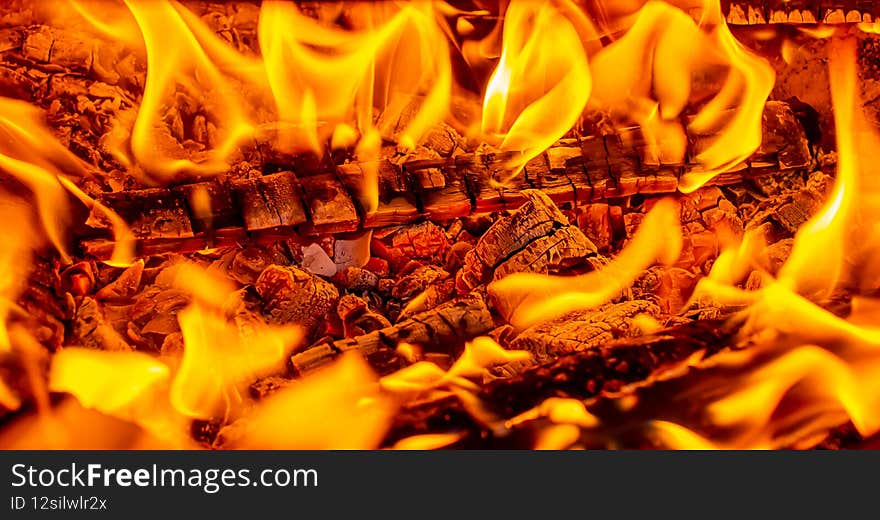 wood is on fire. glowing coals and wood. wood ash. A dying out fire. wallpaper night