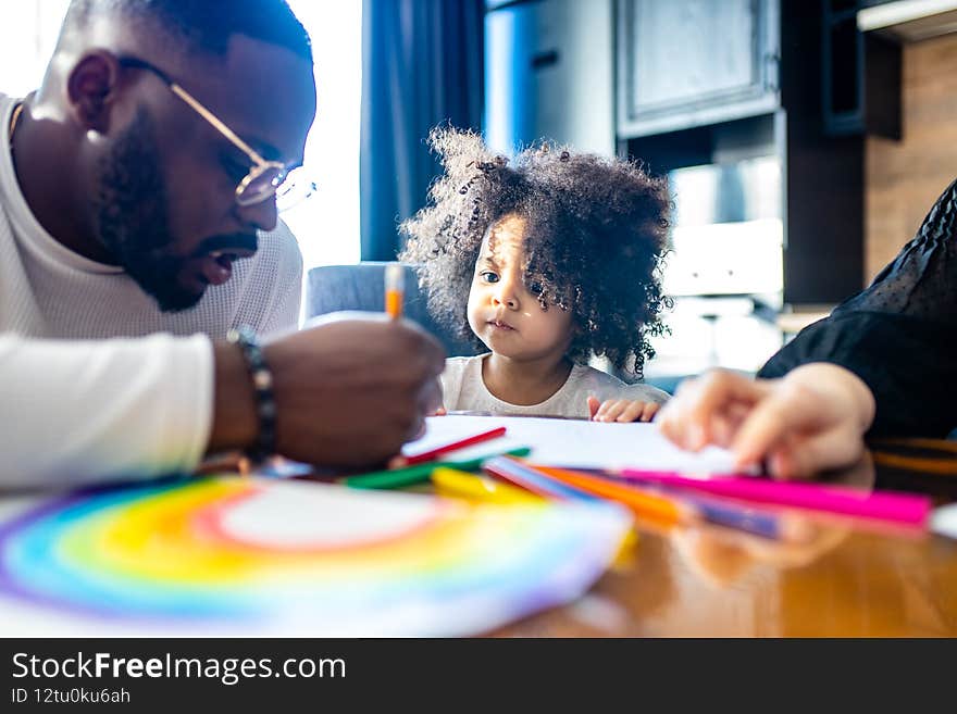 cute curly afro hair girl drawing with her dad parents positive education tolerance.