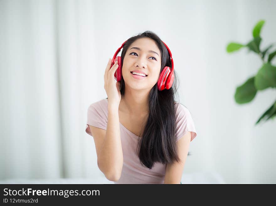 Beautiful woman smile happily and relax while listening to music with headphones. Beautiful woman smile happily and relax while listening to music with headphones