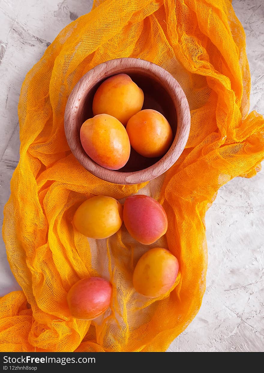 Ripe apricots on a concrete background, healthy, orange minimalism