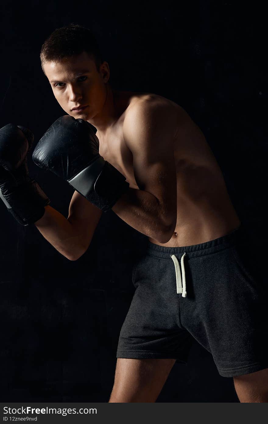 bodybuilder wearing boxing gloves black background cropped view sport . High quality photo