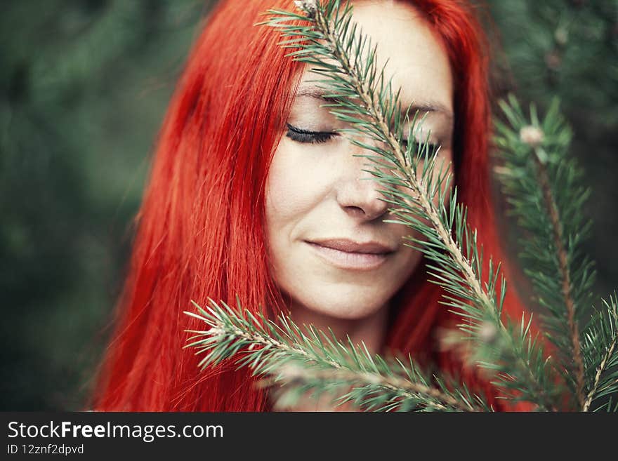 Portrait of Redhead woman on the background of nature