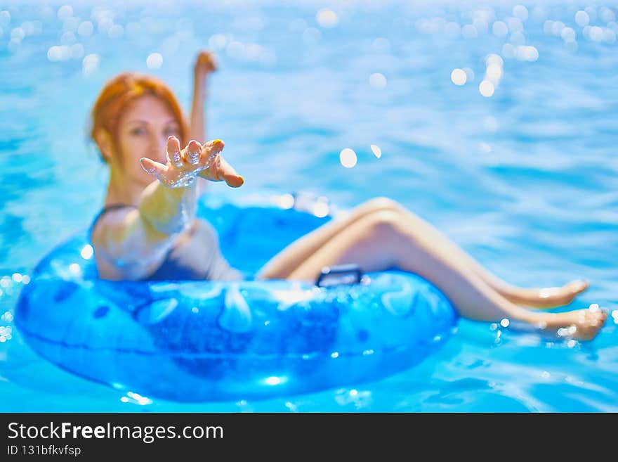Red-haired girl reaches for the camera.