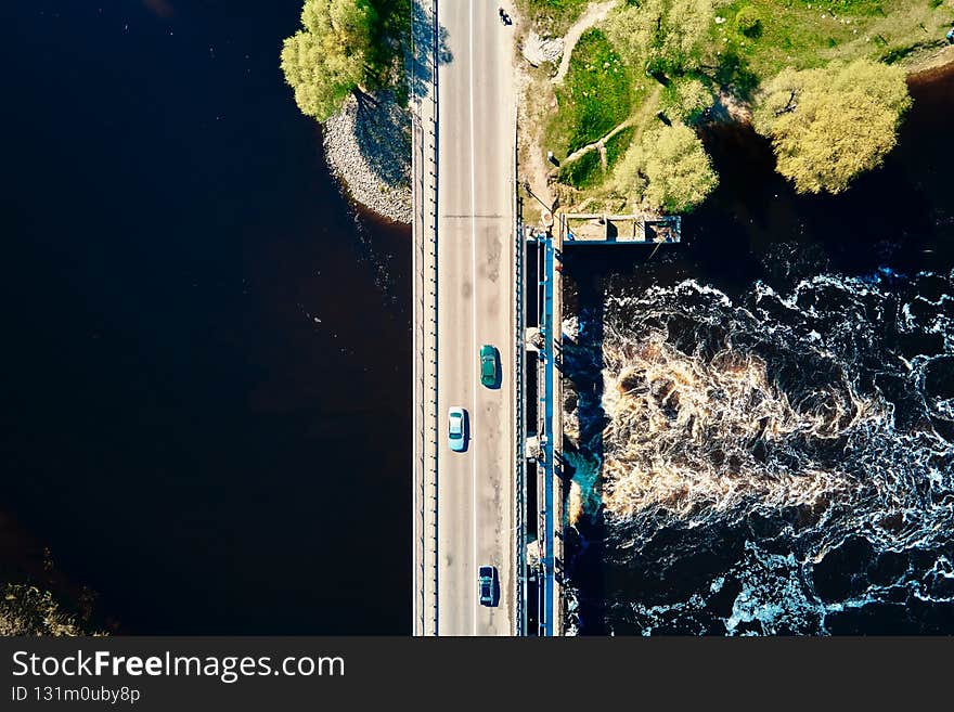 Car moving on bridge in europe small town, aerial view