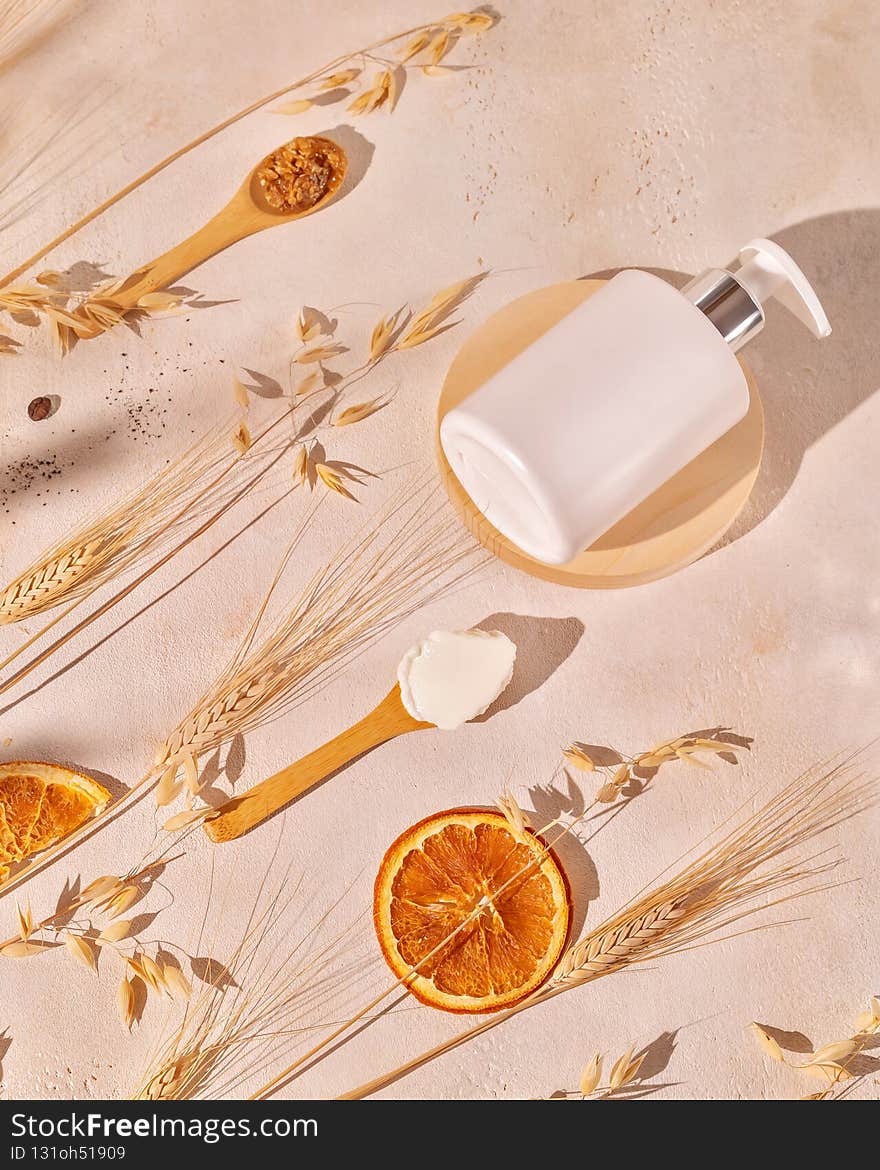 Beauty products mock up of cosmetics based on organic, natural, cereals ingredients. Vertical spa composition with cosmetic bottle, wooden spoons with natural ingredients, ears of rye and wheat. Beauty products mock up of cosmetics based on organic, natural, cereals ingredients. Vertical spa composition with cosmetic bottle, wooden spoons with natural ingredients, ears of rye and wheat