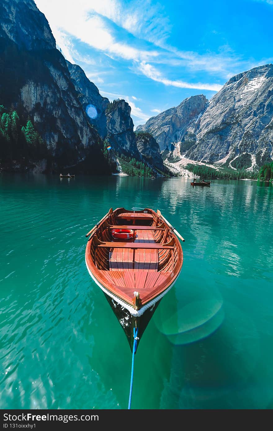 brown wooden boat in clear blue water of mountain lake. copy space