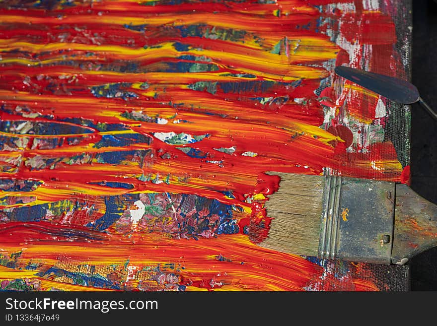 Brush in paint, close-up, on a colorful background, there is a place for text